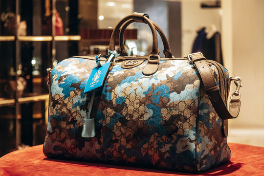 Nice, France - November 14, 2025: Close-up of a Gucci handbag with camouflage monogram pattern displayed in a boutique window in Nice