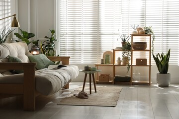 Stylish living room with sofa and houseplants. Interior design
