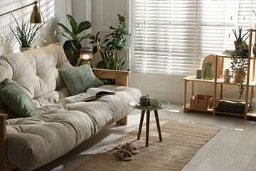 Obraz premium Stylish living room with sofa and houseplants. Interior design