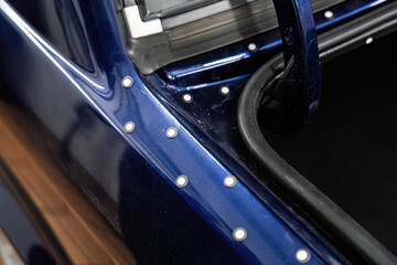 Car trunk with markers applied for a 3D scanner. Preparation for creating a custom subwoofer enclosure or other equipment using 3D modeling.