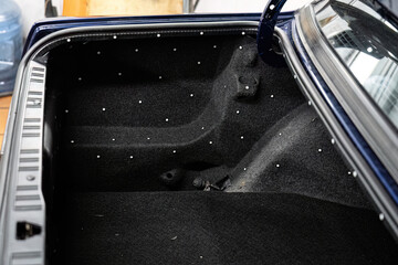 Car trunk prepared with sticker dots (markers) for 3D scanning before custom equipment installation. Industrial digitization and advanced technical automotive service.