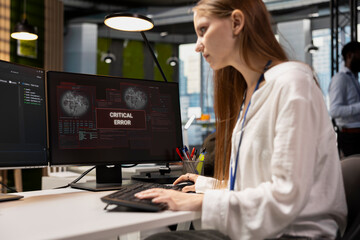 Troubled software developer reviewing error logs at work, trying to to resolve critical glitches. Tense young inexperienced worker debugging code in office, looking for solutions to fix errors