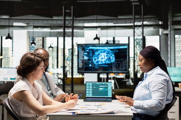 Artificial intelligence supporting HR team as they review digital candidates profiles, applying...