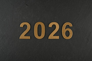Números de año nuevo de 2026 sobre fondo negro, textura de piedra