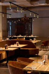 an inviting and brightly lit area complete with rustic wooden furniture and plush seats for relaxation