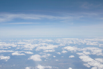 White clouds against a blue sky provide a beautiful backdrop for the natural scenery.