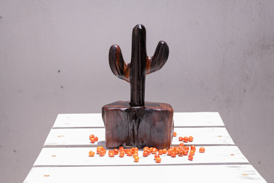 Artisanal wooden chiltepineros and scattered chiltepin peppers