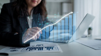 Female professional conducts a detailed analysis of financial data on her laptop, displaying various graphs and charts in a modern office, showcasing business growth strategies. Impute