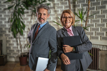 Mature business colleagues posing in office environment