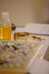 Holy oil and chrism bowl at church baptism ceremony
