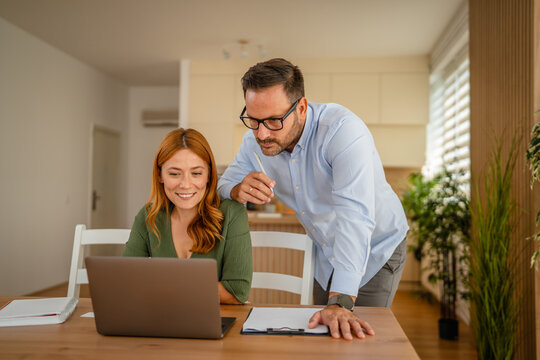 Couple working from home together, enjoying online activity
