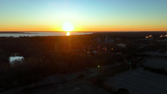 Golden Hour Drone Shot of the Griffon and Apollo's Chariot Roller Coasters against Sunset Sky in Williamsburg, Virginia