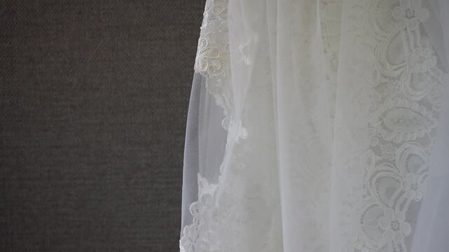 Close Up Lace Veil Against Wall, Delicate Floral Embroidery And Sheer Tulle Draping In Soft Natural Light, Bridal Detail Study For Couture