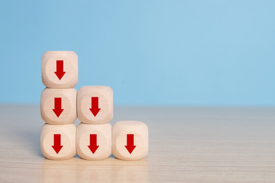 Business decline, performance decrease arrow drop down. Market loss concept diagram in arrow chart wooden block.