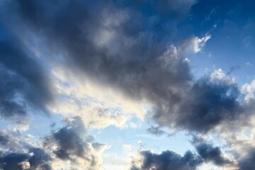 Atmospheric blue sky background with soft glowing clouds and copy space