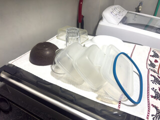 Clean kitchenware air-dries on a charming chicken-patterned towel, showcasing daily household routines and organization.