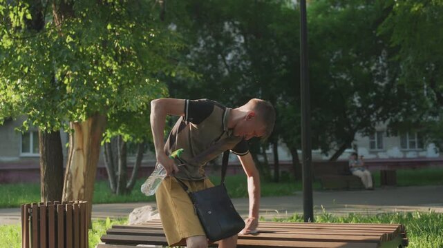 Man Checks Bag, Man Carefully Examines His Backpack Outside, Man Cautiously Inspects His Bag Outdoors Beneath Trees, An Uncertain Man Nervously Looks Through His Bag In Peaceful Suburbia