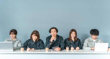 Employees and staff (businessmen and businesswomen) wearing work clothes working at small and medium-sized enterprises such as factories and construction companies