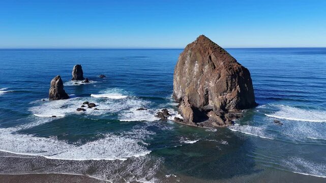 Haystack rock and pillars, waves from above at Cannon Beach