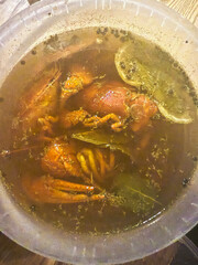 Cooked crayfish soaking in traditional brine with lemon