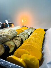 Sliced fresh vegetables preparing for cooking with candlelight