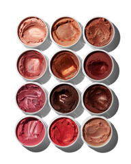 Variety of vibrant makeup colors in small containers for beauty