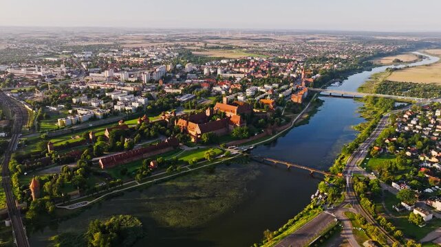 Majestic Malbork Castle and river in golden sunrise light drone perspective