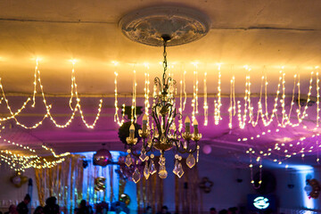 Colorful lighting in a classic space, for parties and celebrations. Colored lights, decorations, flowers, reflections, etc. to illuminate and dance on the dance floor.