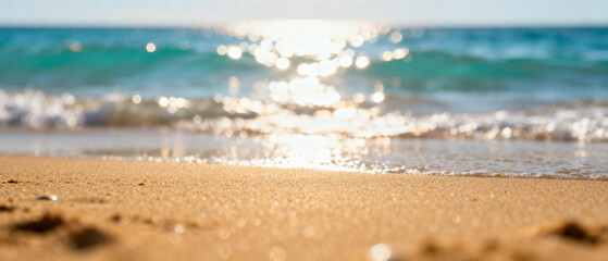 Golden sunlight dancing on gentle ocean waves meeting the soft, warm sand, creating a serene and inviting summer beach scene