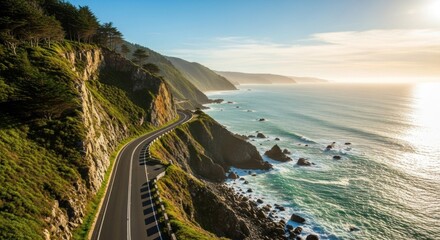 A winding road cutting through a rugged coastline with a car driving along it, surrounded by lush greenery and the ocean.