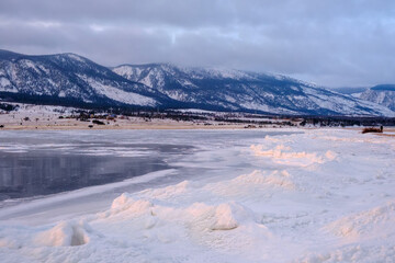 Baikal Lake in winter. Beautiful landscape with mountains reflected in ice of frozen Small Sea