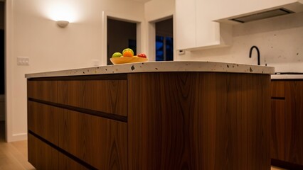 Modern Kitchen Island with Wooden Cabinets and Fruit Bowl.
