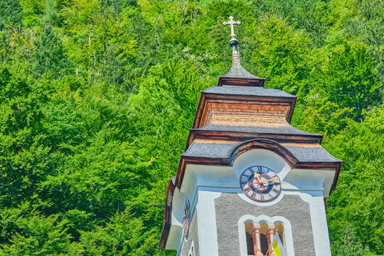 Clock tower of the Catholic parish church of Hallstatt known also as the Hilf Pilgrimage Church together with the world-famous Ossuary contemplative mountain cemetery, Hallstatt, Austria, Europe