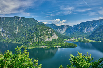Fototapeta premium High angle view of Lake Hallstatt and surrounding mountains of Austrian Alps with the town of Hallstatt on the bank and town of Obertraun in distance, Salzkammergut, Hallstatt, Austria, Europe