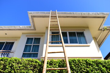 wood ladder for repair house's gutter before rainy season