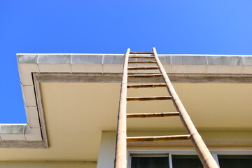 wood ladder for repair house's gutter before rainy season