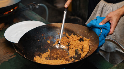 Asian chef cooking street food in hot wok