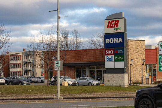 Canada, Quebec, 08 November 2025 : Cloudy autumn day at suburban shopping complex with various businesses.