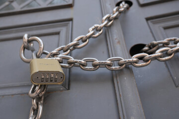 Chain and lock securing a door at a closed location