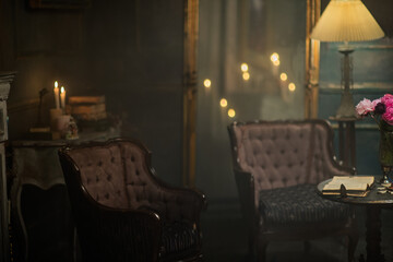 blurred background with vintage interior with candles and armchairs