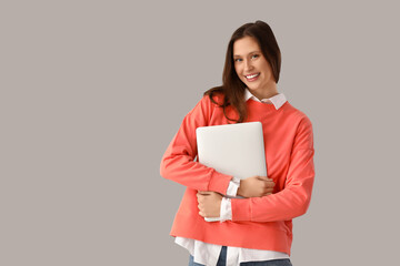 Fototapeta premium Female office worker with laptop on light background