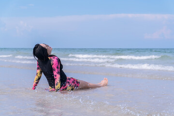 Happy Woman Relaxing on Beach in Swimsuit under Blue Sky