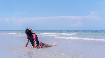 Happy Woman Relaxing on Beach in Swimsuit under Blue Sky