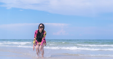 Happy Asain Woman Enjoying Beach Lifestyle in Swimsuit