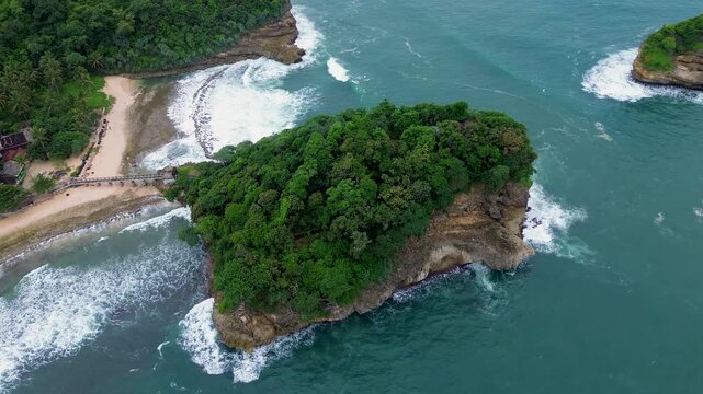 Top Down Drone View of Ocean Waves Crashing on Rocky Coast, Ngliyep Beach Indonesia