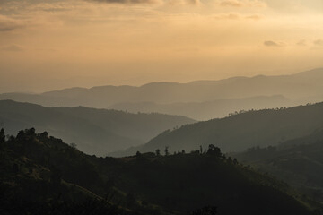 Fototapeta premium Serene Mountain Landscape at Dusk with Layered Hills and Soft Hues in the Sky Offering a Tranquil Nature Escape for Adventurous Souls