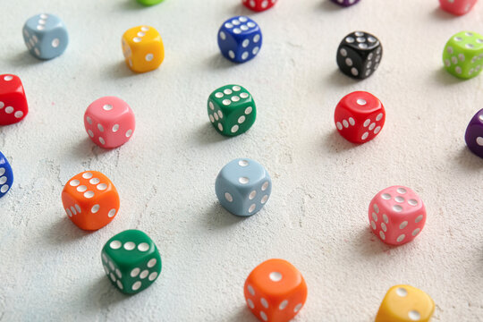 Many colorful dices on light background