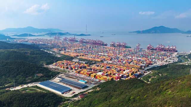 Aerial shot of large container port with shipping and crane near sea in Ningbo, China. 