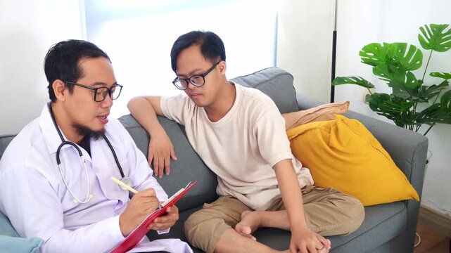Caring doctor consults with young man with down syndrome
