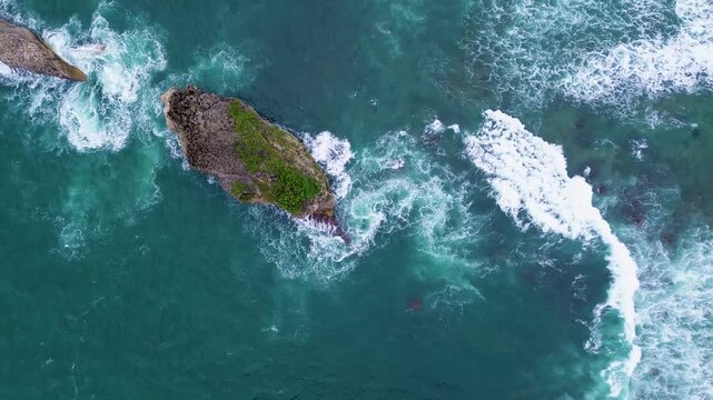 Top Down Drone View of Ocean Waves Crashing on Rocky Coast, Ngliyep Beach Indonesia